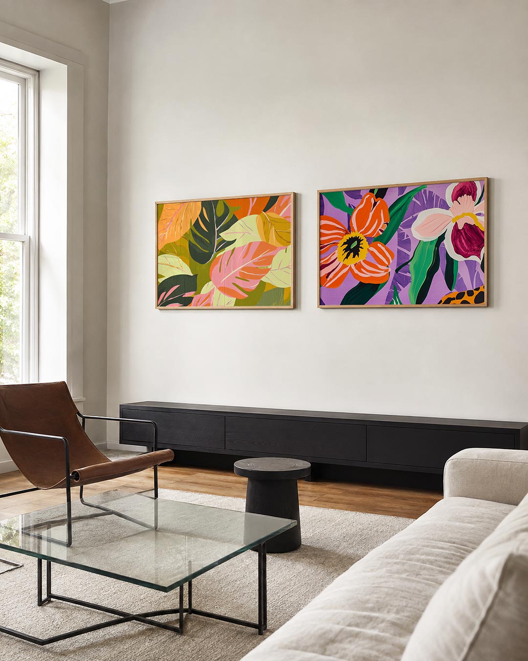 Tweedelige posterset met grote bladeren in roze, groen en oranje tinten, getoond in een interieur
