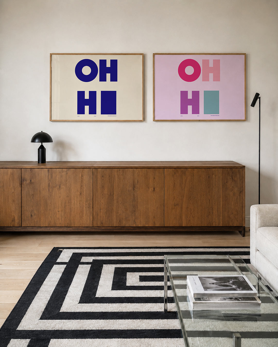 Twee liggende posters met grote, blauwe letters op een lichte achtergrond, aan de muur in een interieur